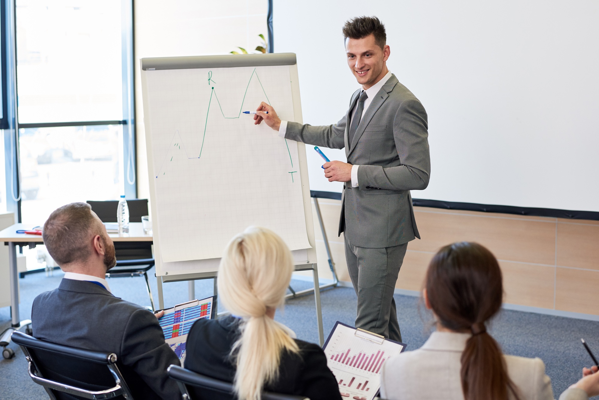 Business Coach Pointing at Graph